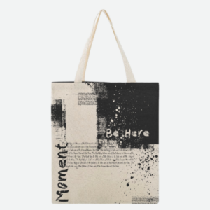 Black and white graphic canvas bag with the texts Moment and Be Here.